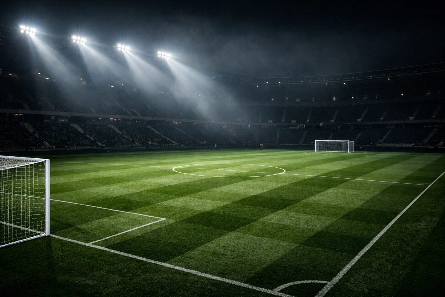 Campo de fútbol iluminado de noche con reflectores creando una atmósfera de competición europea